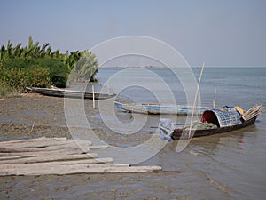 Old boats on the shore in Yoe Ngu Village, Myanmar, on a sunny day