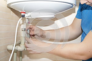 Old boiler is broken, repair and installation of a new water heater. Hired mechanic eliminates breakdown