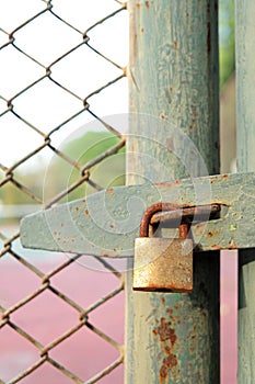 Old bolt and padlock on the door tennis court