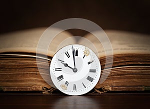 Old book and antique clock face, storytelling background