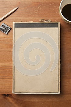 Old book blank cover on a wooden table