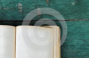 An old book with blank pages on a blue wooden background
