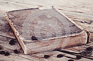 Old book in coffee beans closeup