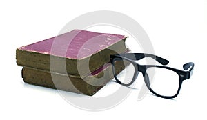 Old book and glasses on a white