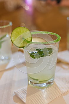 The glass with lemonade, lemon and mint photo