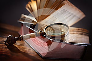 Old book and magnifying glass