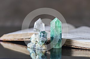 Old book and mineral stones crystals. Crystal Ritual, Healing Crystals. Natural gemstones. Gemstones are full of healing