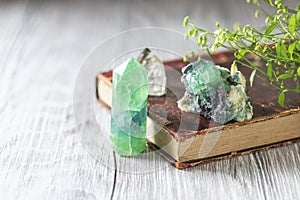 Old book and mineral stones crystals. Crystal Ritual, Healing Crystals. Natural gemstones. Gemstones are full of healing