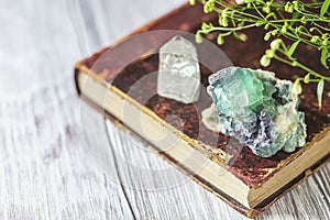 Old book and mineral stones crystals. Crystal Ritual, Healing Crystals. Natural gemstones. Gemstones are full of healing