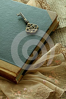 Old book and old key - retro composition