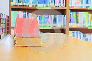 old book red and heap treatise in school library on wooden table