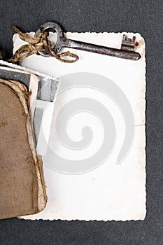 Old book, rusty key and empty photograph
