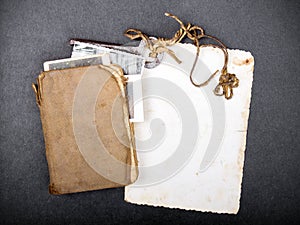 Old book, rusty key and empty photograph