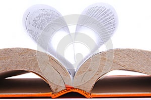Old book with sheets that form a heart shape