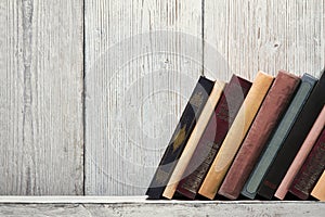 Book shelf blank spines, empty binding stand on wood texture