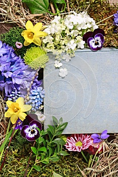 Old book among spring flowers, copy space