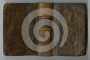 Old book, vintage and cover of manuscript, ancient scripture or antique literature against a studio background. Closeup