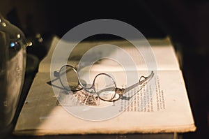 Old book and vintage glasses