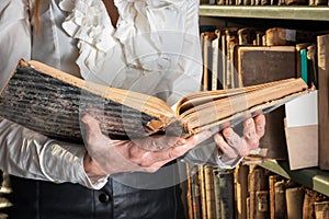 Old book in woman`s hands. concept of wisdom, reading, imagination