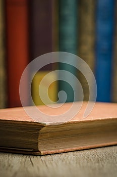 Old book on wooden shelf