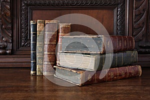 Old books on an antique wooden furniture