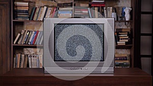 Old books background retro television set. Bad television signal noise. Room old tv set. 90s retro tv screen static