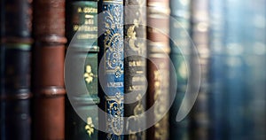 Old books close-up. Title of the book is printed on the spine, book cover. Tiled Bookshelf background. Concept on the theme of