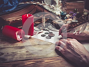 Female hand writes the letter with feather quill pen.