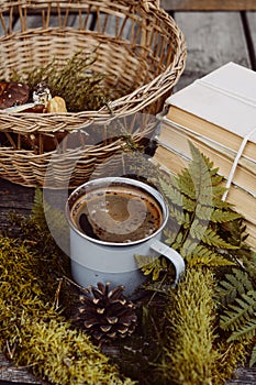 Old books and cup of coffee on dark wooden background