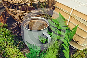 Old books and cup of coffee on dark wooden background