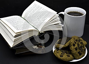 Old books with leather covers about to read. A cup of coffee or tea and vegan cookies ready to drink