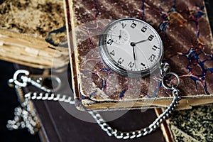 Old books and pocket watch