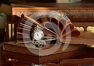 Old books and pocket watch with chain