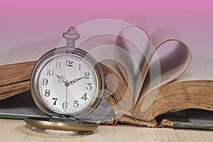 Old books and pocket watches on desk