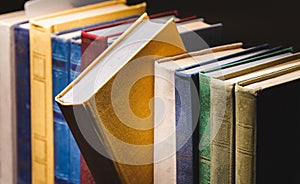 Old Books In A Row In Vintage Library On Black Background Close-up