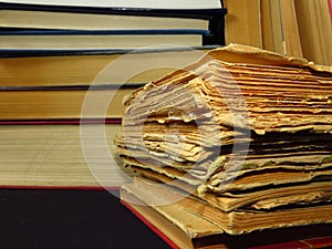 Old books stacked in a pile. Education, knowledge, reading habits, paper, library.