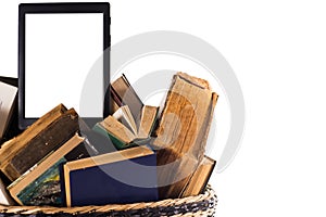 Old books in a trash can and an e-book as a symbol of new technologies. White background, space for text