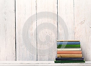 Old Books on Wood Shelf, Spine Cover over White Wooden Wall