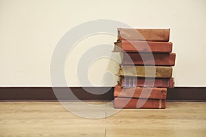 Old books on a wooden floor - Book stack in the library room for business and education wall background , back to school concept