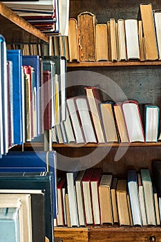 Old books on a wooden shelf