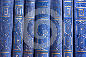 Old books on a wooden shelf.