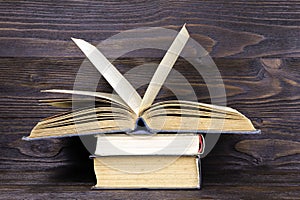 Old books on a wooden shelf. Retro books on wooden background. Stack of books