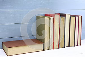 Old books on a wooden shelf. Retro books on wooden background. Stack of books. Copy space. Space for text