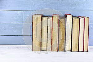 Old books on a wooden shelf. Retro books on wooden background. Stack of books. Copy space. Space for text