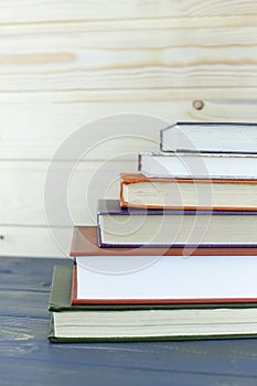 Old books on a wooden shelf. student`s books on the table