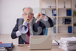 Old boss employee holding magaphone at workplace
