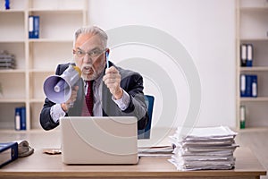 Old boss employee holding magaphone at workplace photo