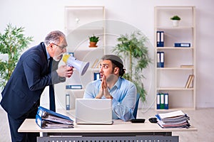 Old boss and his young assistant in the office