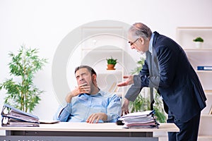 Old boss and his young assistant in the office