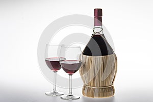 Old bottle and glasses of chianti wine photo